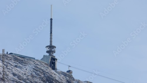 One of the Ulriksbanen cable cars just as it reaches the upper station at mount Ulriken at a sunny winter day photo