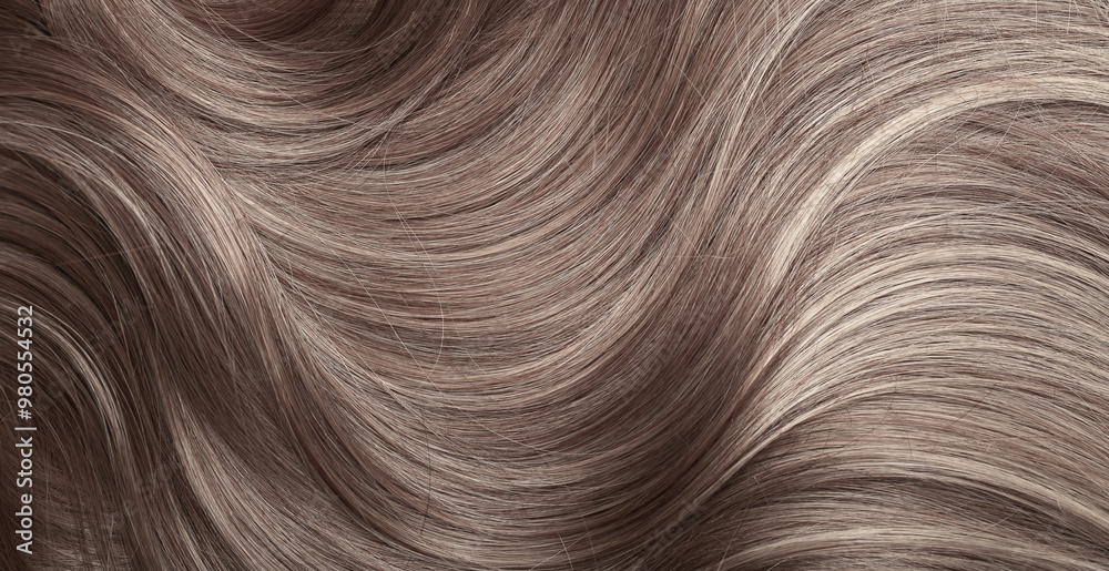 Blond hair close-up as a background. Women's long light brown hair. Beautifully styled wavy shiny curls. Hair coloring. Hairdressing procedures, extension.
