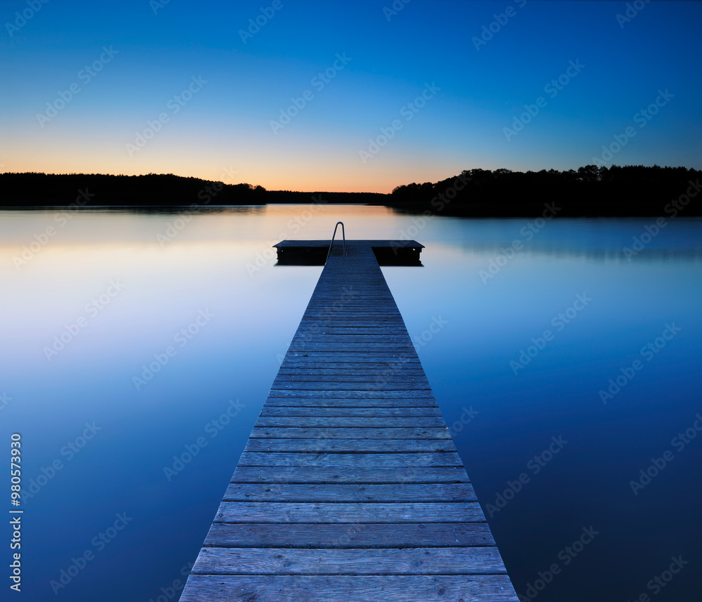 Obraz premium Wooden Pier by Calm Lake at Dusk