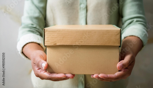 Close-Up of Hands Holding a Donation Box