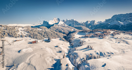 Cold winter scene of Italian ski resort. Bright morning view of Dolomite Alps. Bright winter scene of Alpe di Siusi village, Ityaly, Europe. Vacation concept background. photo