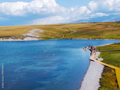 Aerial photography of the famous Sayram Lake and grassland pastures in Xinjiang, China photo