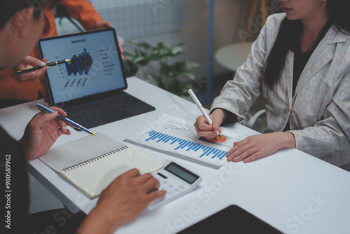 Business team giving advice Meeting and brainstorming, financial investment, real estate project, strategy, planning, calculation, pointing at graph chart on desk at office.