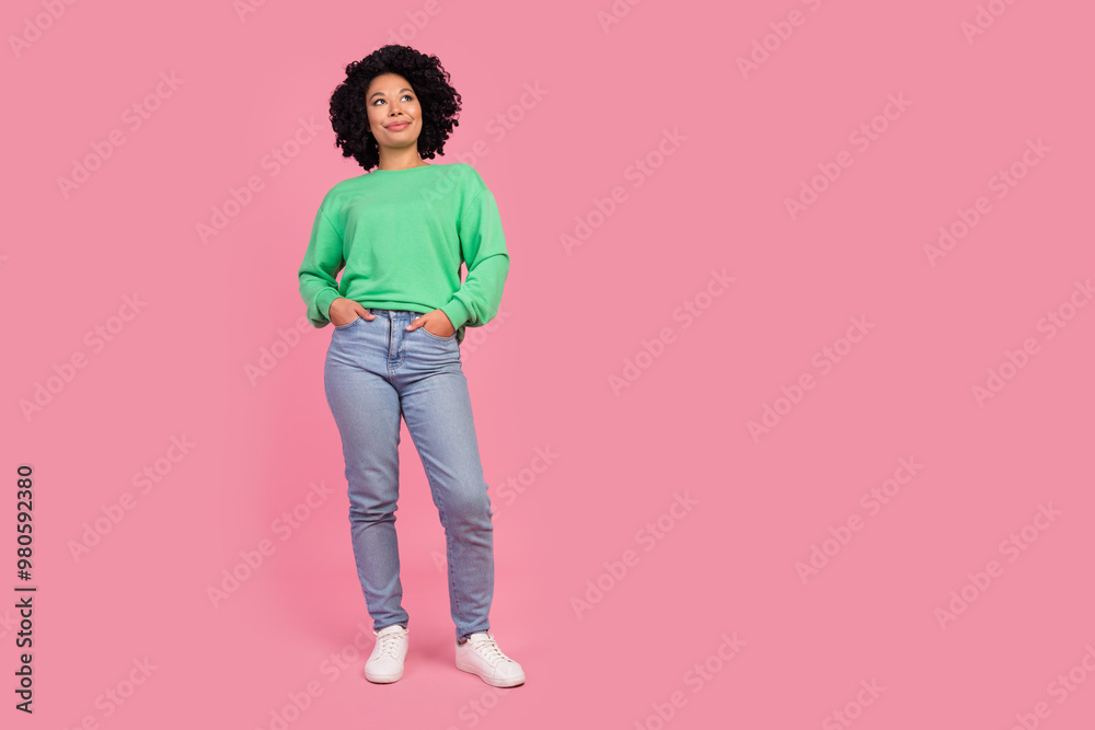 Full length photo of shiny attractive lady dressed green pullover smiling looking empty space isolated pink color background Full length photo of shiny attractive lady dressed green pullover smiling looking empty space isolated pink color background
