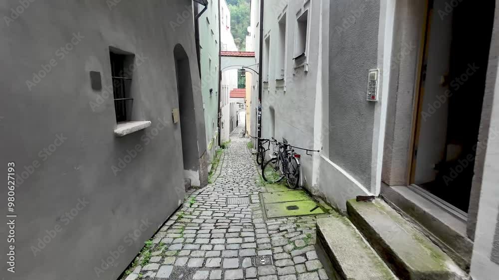 Passau, Germany narrow cobbled street with bicycles and painted cobblestone on the ground