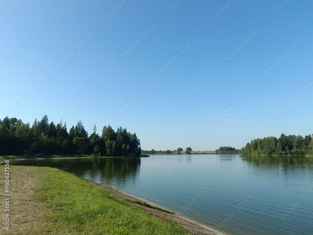 Bubiai lake during sunny day. Sunny day with white and gray clouds in blue sky. Wavy lake. Horizon over water. Bubiu ezeras. Bubiai lake during sunny day. Sunny day with white and gray clouds in blue sky. Wavy lake. Horizon over water. Bubiu ezeras.