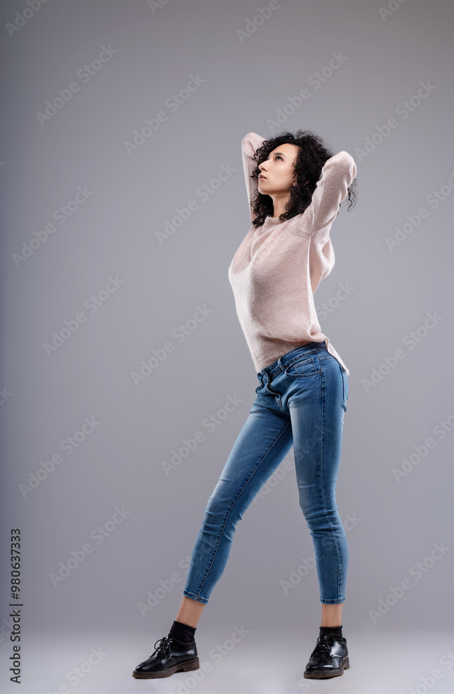 Fashion model posing with hands holding her head Fashion model posing with hands holding her head