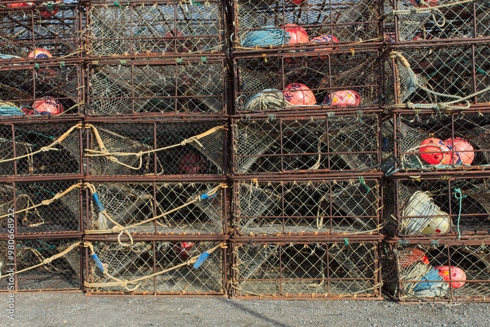 Closeup of empty old rusty crab cages stacked on the ground. 