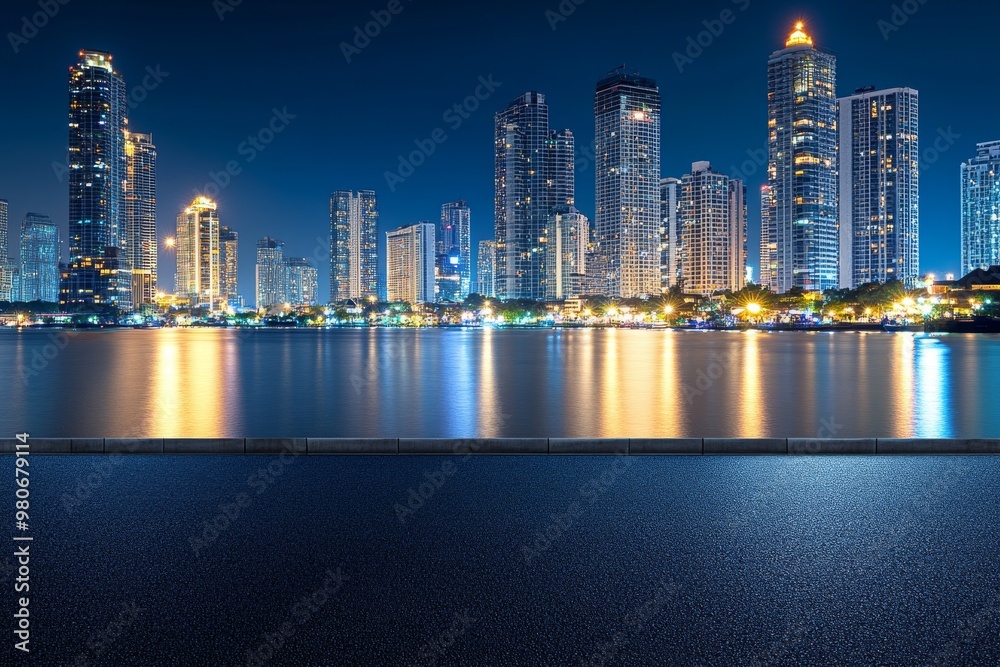 Fototapeta premium Cityscape at night with a reflection of buildings in the water.
