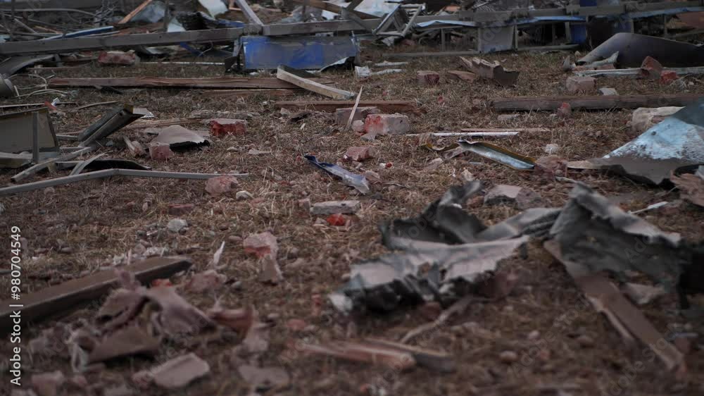 Aftermath of Destruction: Broken bricks, wooden splinters, and mangled metal sheets lie scattered across the barren ground, painting a picture of desolation Aftermath of Destruction: Broken bricks, wooden splinters, and mangled metal sheets lie scattered across the barren ground, painting a picture of desolation
