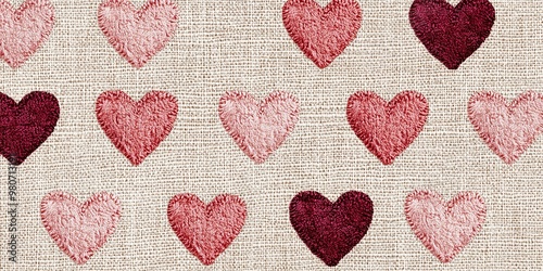 Fabric with multiple pink and red hearts.