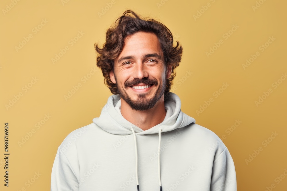 Portrait of a blissful man in his 30s wearing a thermal fleece pullover over soft yellow background Portrait of a blissful man in his 30s wearing a thermal fleece pullover over soft yellow background