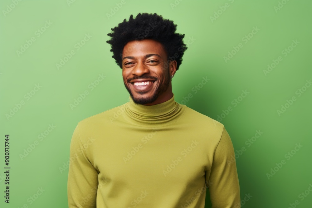 Portrait of a cheerful afro-american man in his 30s wearing a classic turtleneck sweater isolated on soft green background Portrait of a cheerful afro-american man in his 30s wearing a classic turtleneck sweater isolated on soft green background