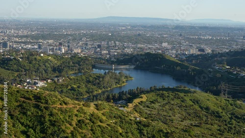Hollywood Reservoir against a backdrop of sprawling homes and winding roads. Urban and natural coexistence concept.