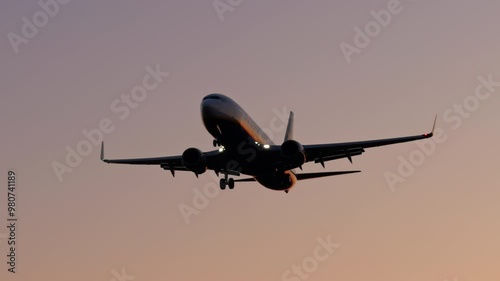 Large airliner with passengers on blue sky is landing on landing strip at airport of bright sunset on sunny summer day Go Everywhere. Airplane flies in sky at sunset