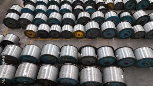 large amount of spools of steel wire are stored in factory.  industrial grade metal electrical wire rope