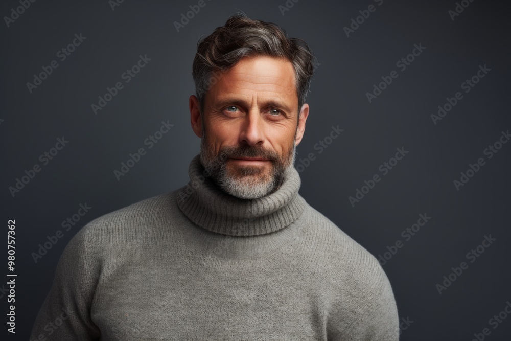 Portrait of a tender man in his 40s wearing a classic turtleneck sweater in front of soft gray background Portrait of a tender man in his 40s wearing a classic turtleneck sweater in front of soft gray background