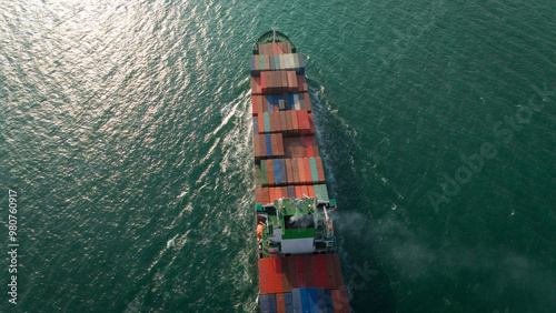 Aerial top view over international containers cargo ship at industrial import-export port prepare to load containers with big container loader ship vessel. global transportation and logistic business