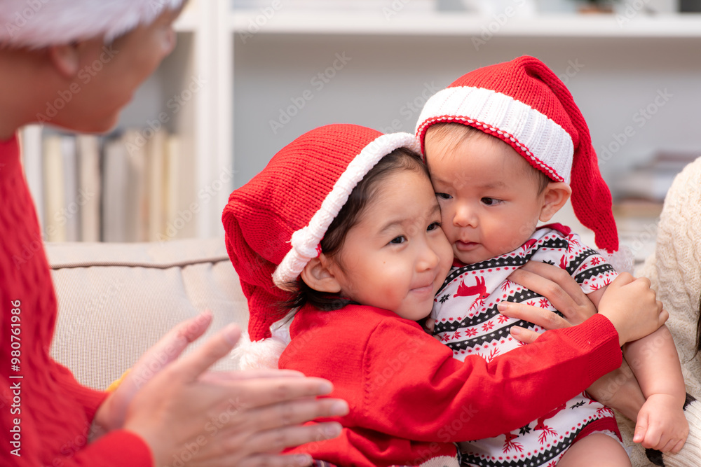 Parents and their two children are dressed in Christmas outfits to celebrate the Christmas holiday at home Parents and their two children are dressed in Christmas outfits to celebrate the Christmas holiday at home