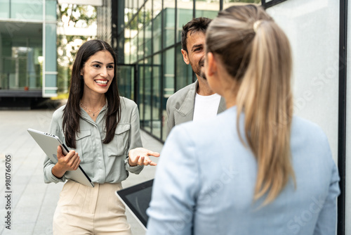 Group of young successful professional business people standing outside office building discussing opportunities and prepare for corporate staff meeting of employees. Occupational and employee concept