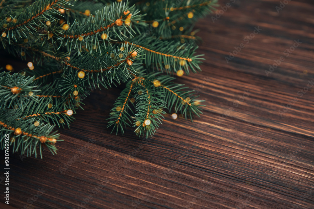 New Year, Christmas background. Branches of a green Christmas tree on a dark wooden background. Top view New Year, Christmas background. Branches of a green Christmas tree on a dark wooden background. Top view