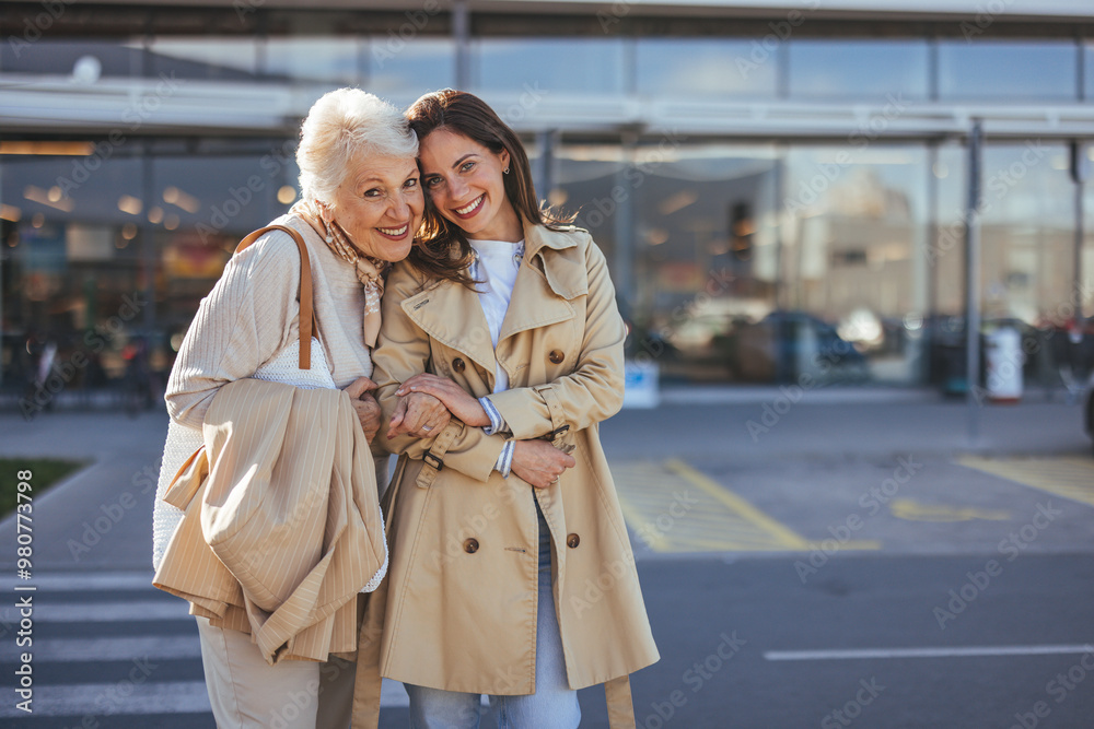 Obraz premium Smiling Grandmother and Granddaughter Embracing Outside Shopping Center