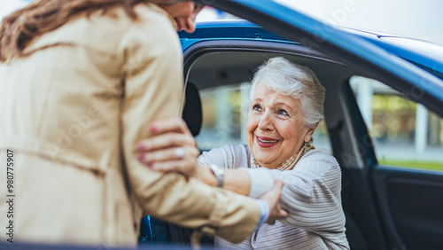 Quadro su tela Joyful Senior Woman Being Helped Out Of Car By A Friend