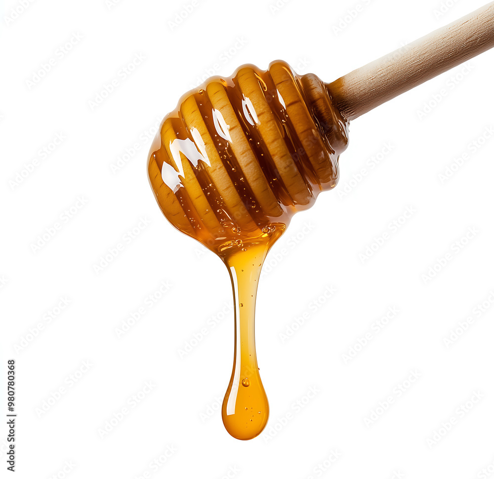 Golden honey dripping from a dipper, isolated on white background.