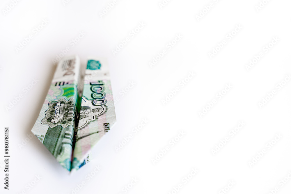airplane made from a thousand ruble bill on a white background with space for text airplane made from a thousand ruble bill on a white background with space for text