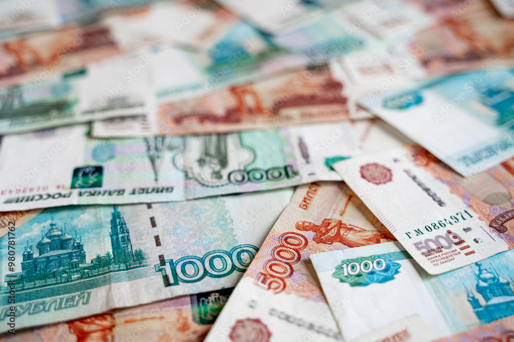 Russian money rubles with a denomination of one thousand rubles and five thousand rubles lie on the entire background of the image, green and expensive Russian money rubles with a denomination of one thousand rubles and five thousand rubles lie on the entire background of the image, green and expensive