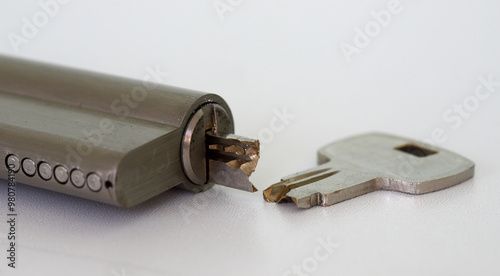 Close-up of broken key and lock with half key inside photo