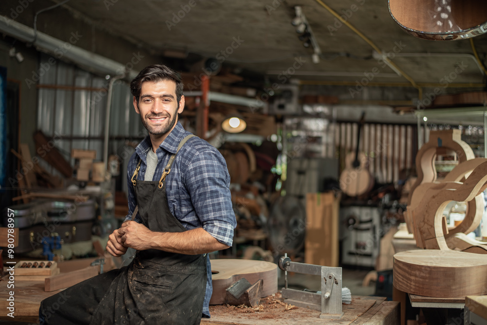 Portrait of guitar luthier small business owner in workroom Portrait of guitar luthier small business owner in workroom