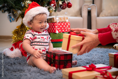 A little child in a Christmas outfit is celebrating the Christmas holiday with their family at home