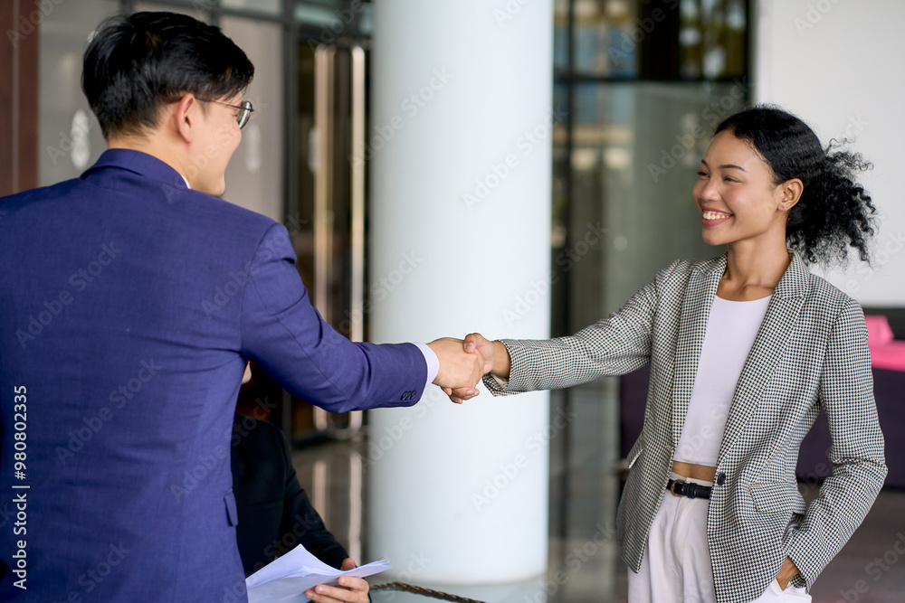Businessman shake hand with businesswoman in casual form in co-working space for celebrate to join work or welcome. Businessman shake hand with businesswoman in casual form in co-working space for celebrate to join work or welcome.