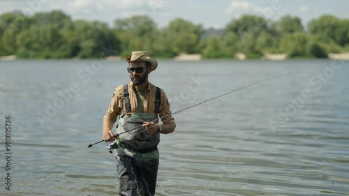 Fisherman casts his line into lake hoping to catch perch or pike	