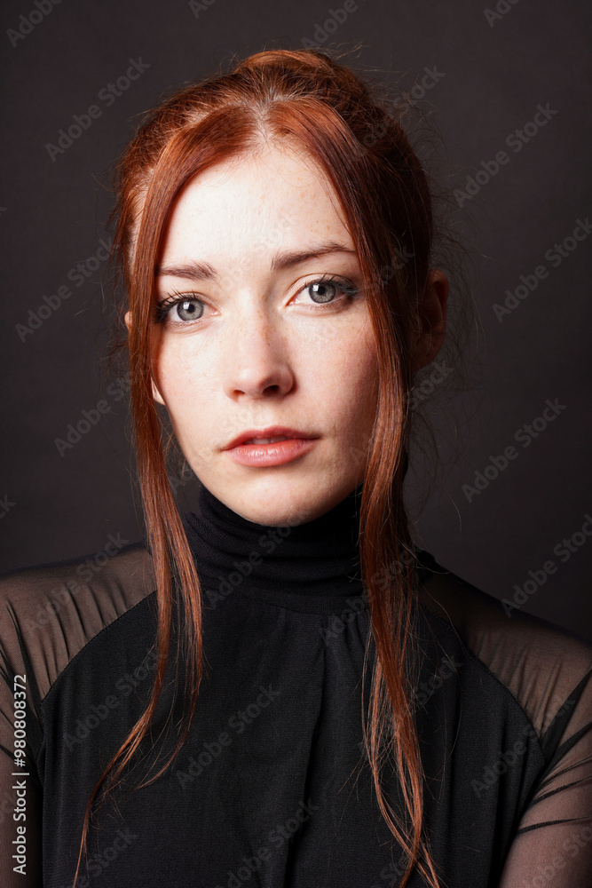 vertical portrait of redhead woman with hair tendrils and freckles wearing elegant black turtleneck vertical portrait of redhead woman with hair tendrils and freckles wearing elegant black turtleneck