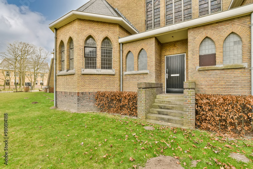 Traditional brick church exterior with arched windows photo