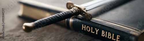 Close-up of a sword resting on a Holy Bible, symbolizing faith, strength, and spiritual warfare.