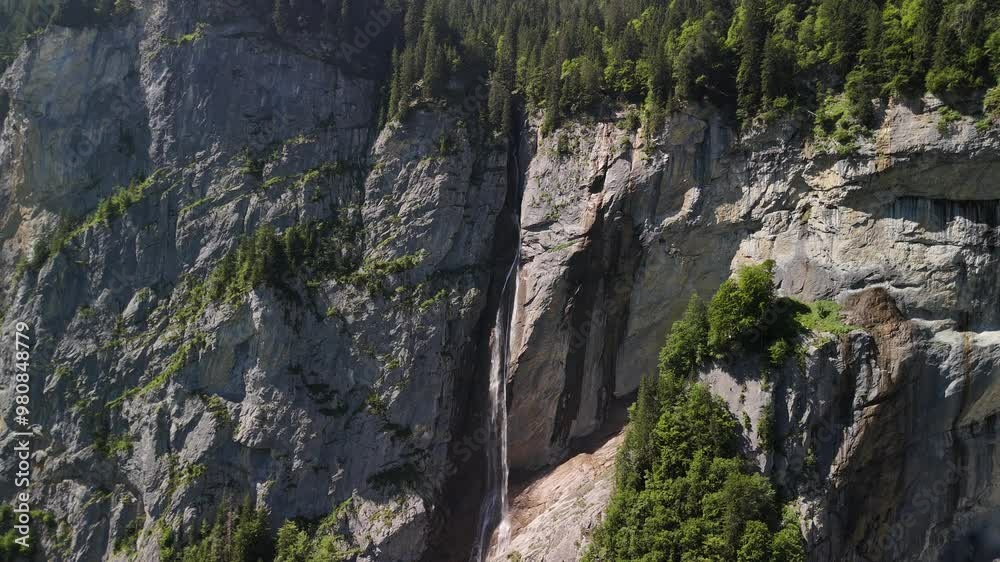 Waterfall rocky cliff Swiss Alps mountain side forest covered, Switzerland Waterfall rocky cliff Swiss Alps mountain side forest covered, Switzerland