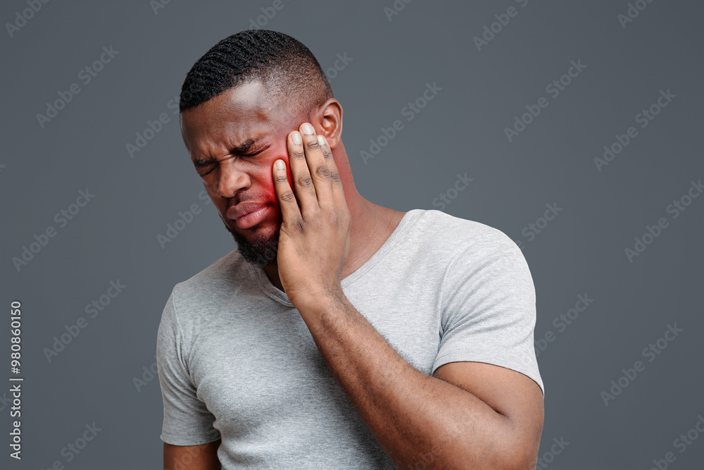 Young afro man having impacted tooth problem, need for surgery, copy space Young afro man having impacted tooth problem, need for surgery, copy space
