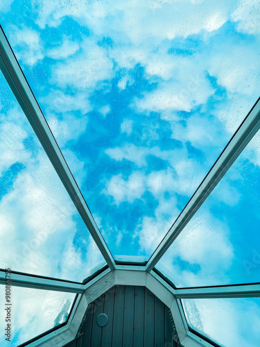 Glass Ceiling of an Glass Igloo Looking Up into the Cloudy Sky