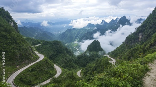 The view from the top of Tianmen Mountain, looking down over the stunning, winding roads and cloud-kissed peaks.