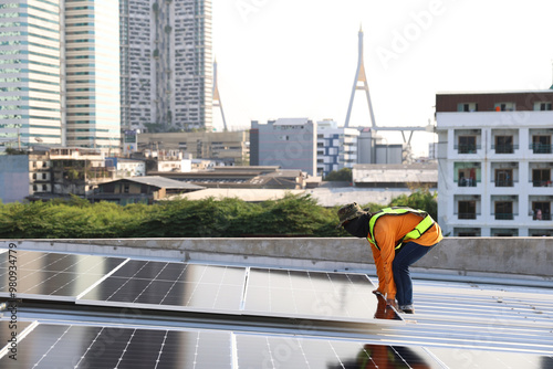 Technicians Install photovoltaic solar modules on roof of house. Engineers install or fix solar cells in roof of house. Technician worker on solar panels. Solar panel technician  working on house roof photo