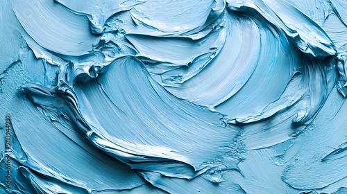 Light blue paint texture is captured in close-up, showcasing thick brush strokes and a glossy surface with visible ridges, emphasizing rich abstract painting details. photo