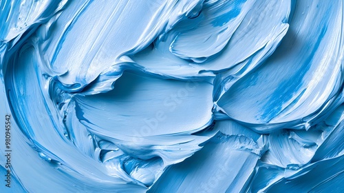 Light blue paint texture is captured in close-up, showcasing thick brush strokes and a glossy surface with visible ridges, emphasizing rich abstract painting details. photo