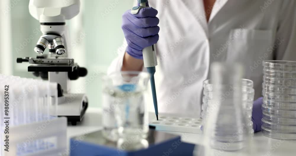 Laboratory assistant conducts professional examinations of liquid sample. Checking quality of water in lab Laboratory assistant conducts professional examinations of liquid sample. Checking quality of water in lab
