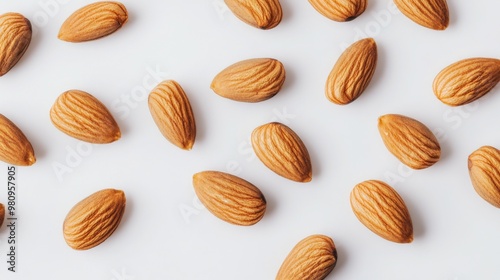 Wallpaper Mural A close-up of raw almonds scattered on a white background, showcasing their natural texture and shape in a clean, minimalist setting. Torontodigital.ca