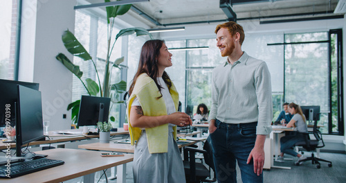 Φωτογραφία Satisfied mixed-raced workers talking with each other during free time at work