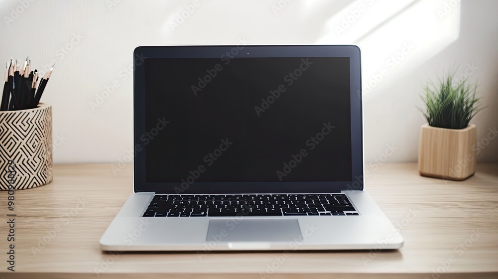 A modern laptop with a closed lid, resting on a minimalist desk A modern laptop with a closed lid, resting on a minimalist desk
