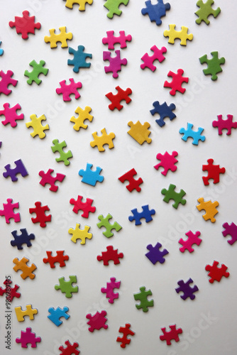 Colorful jigsaw puzzle pieces on white background. Flat lay.